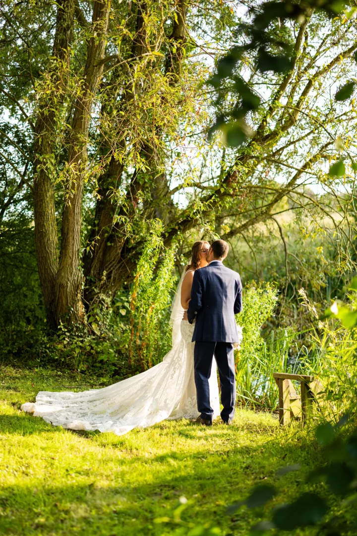 Newly Married couple kissing near tree