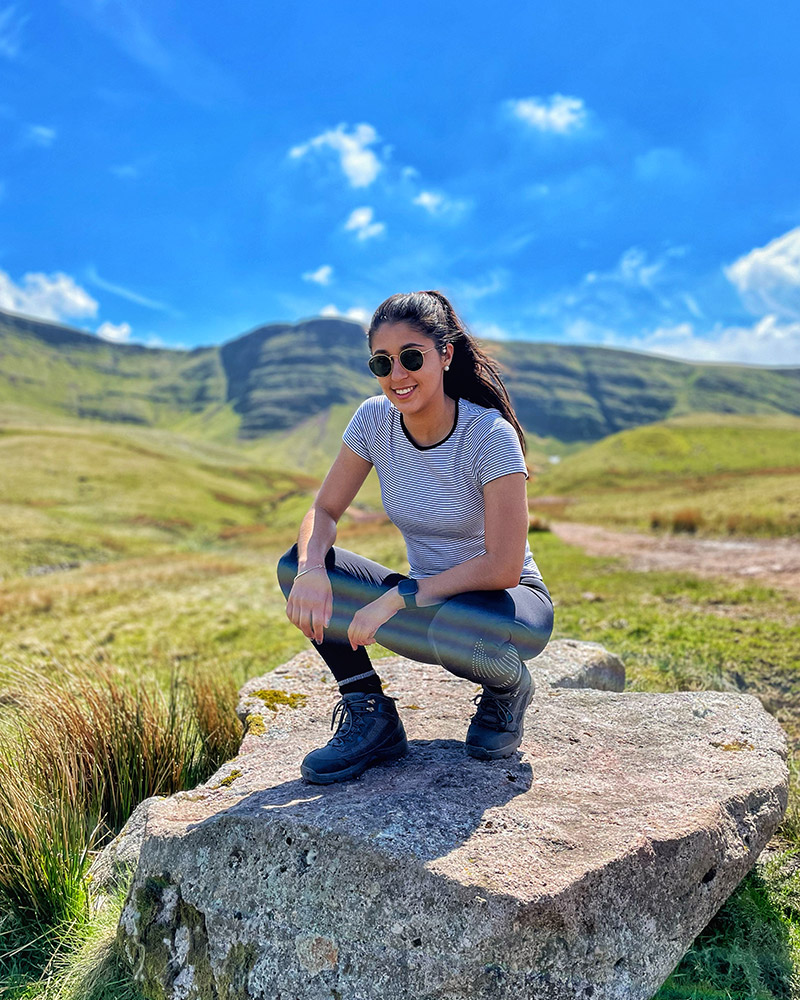 Wedding photographer enjoying mountain hike in countryside