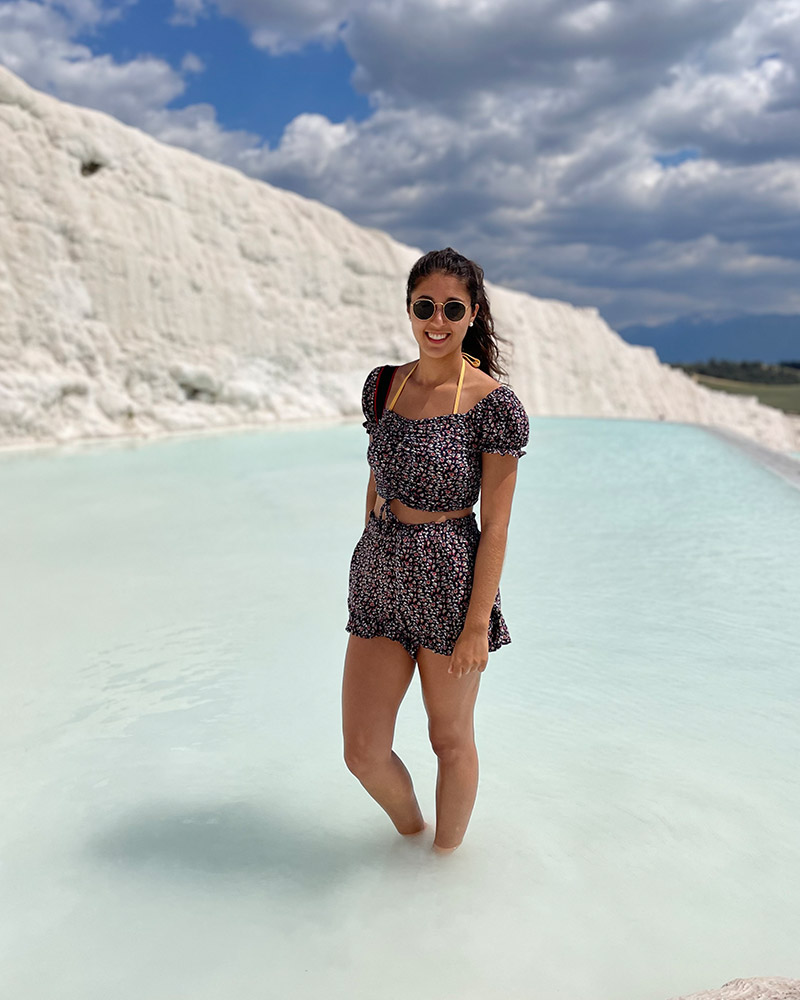 Wedding photographer standing by natural thermal pools on holiday