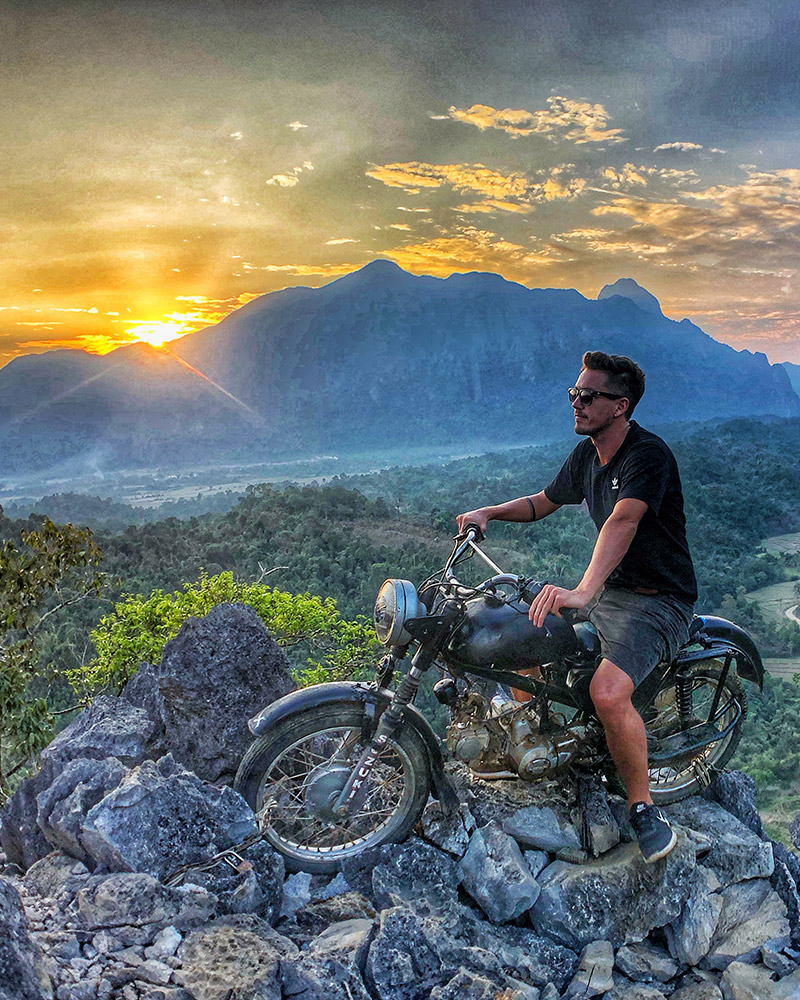 Wedding videographer enjoying sunset view on motorbike adventure