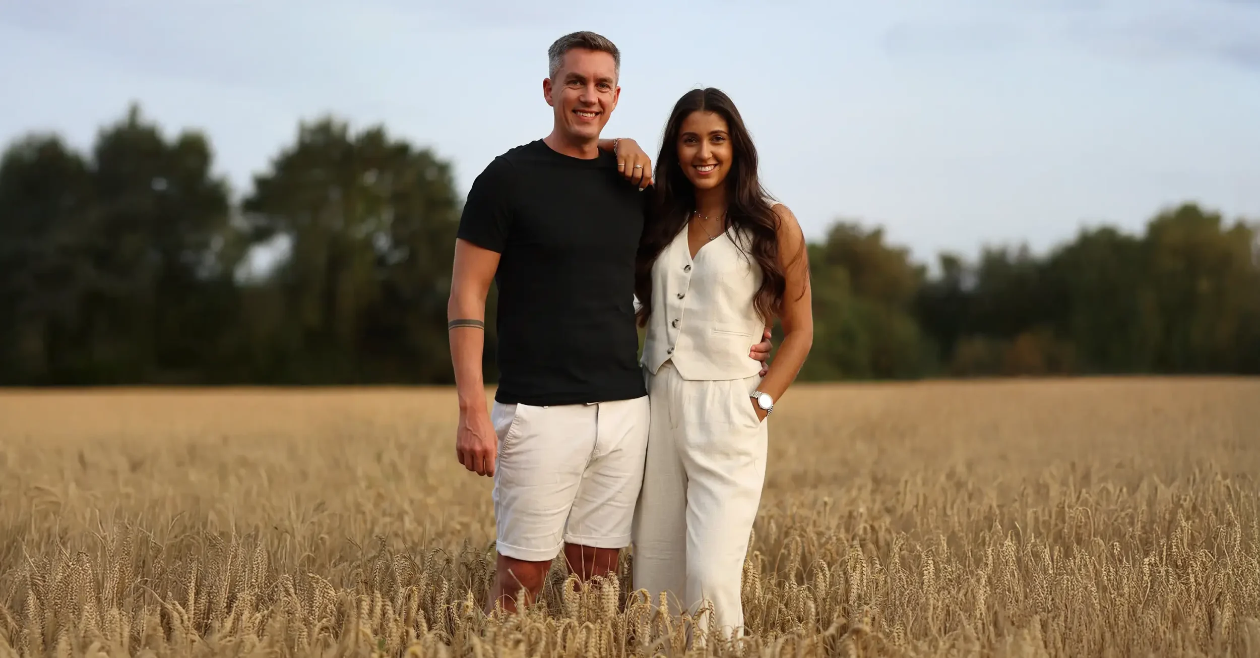 Wedding photographer and videographer posing together outdoors