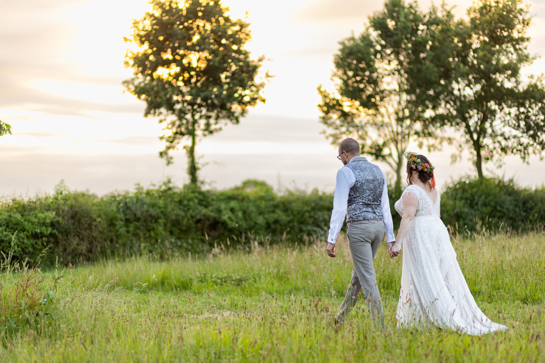 Wedding photography of couple walking together at sunset