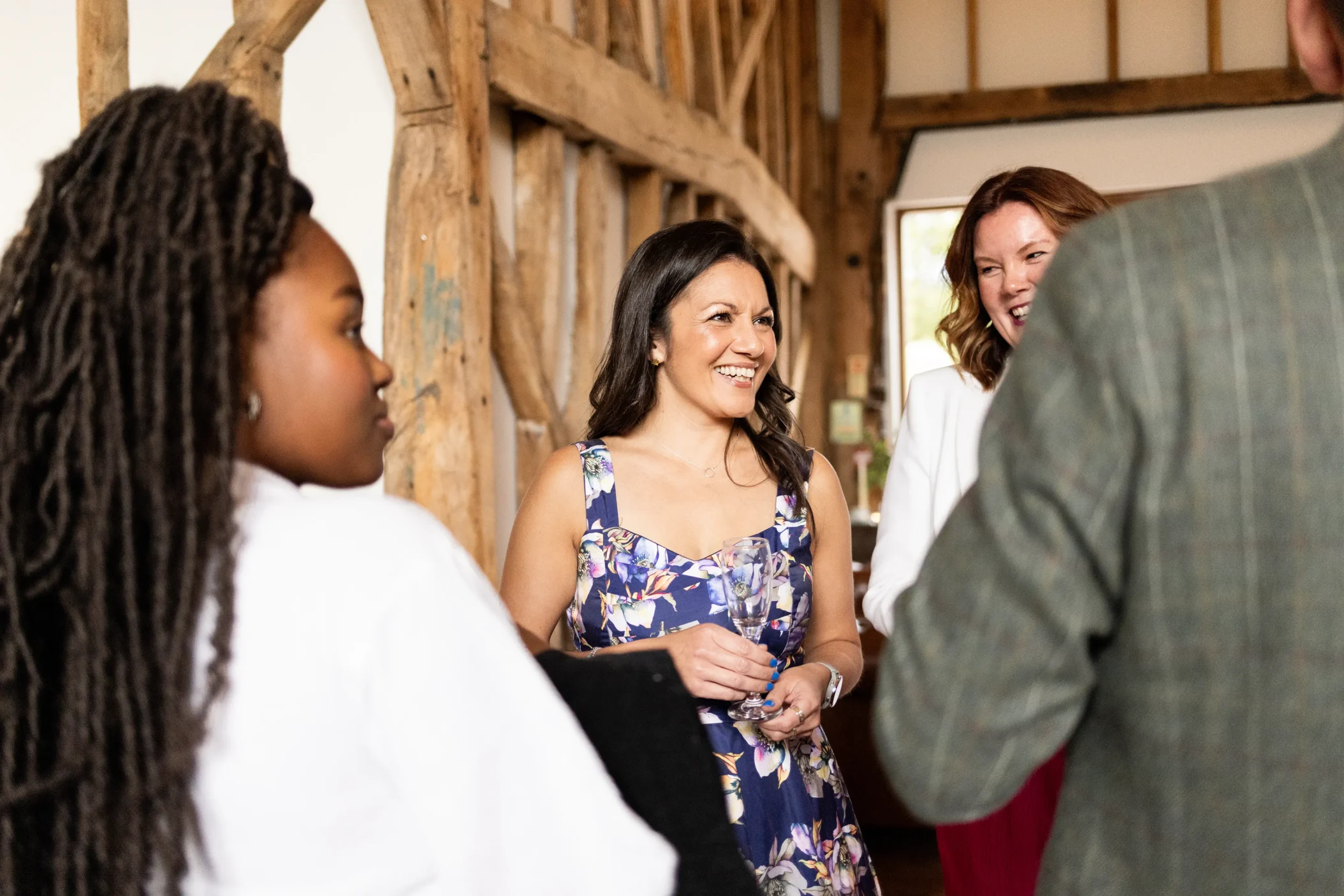 Guests enjoying the wedding atmosphere inside a rustic barn wedding venue beautifully filmed in wedding videography.